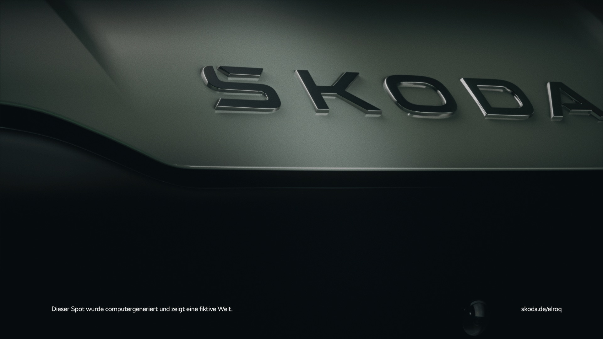 Still from the Skoda Elroq commercial – close-up of the chrome SKODA lettering on a dark green car body 